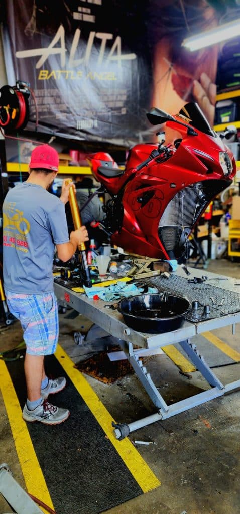 motorcycle maintenance on a red motorcycle.