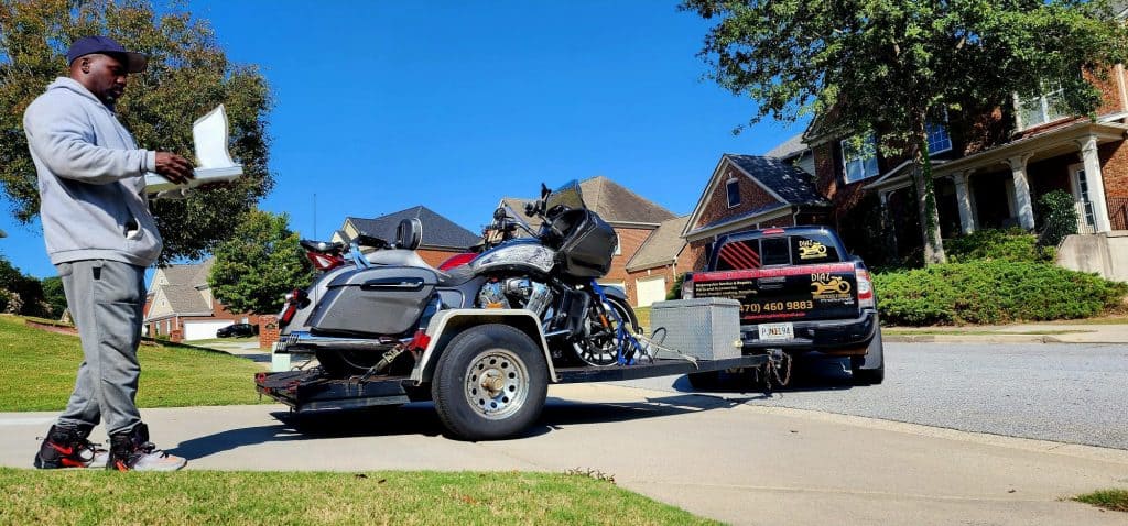 motorcycle being loaded onto trailer for transport by Diaz motorcycles.