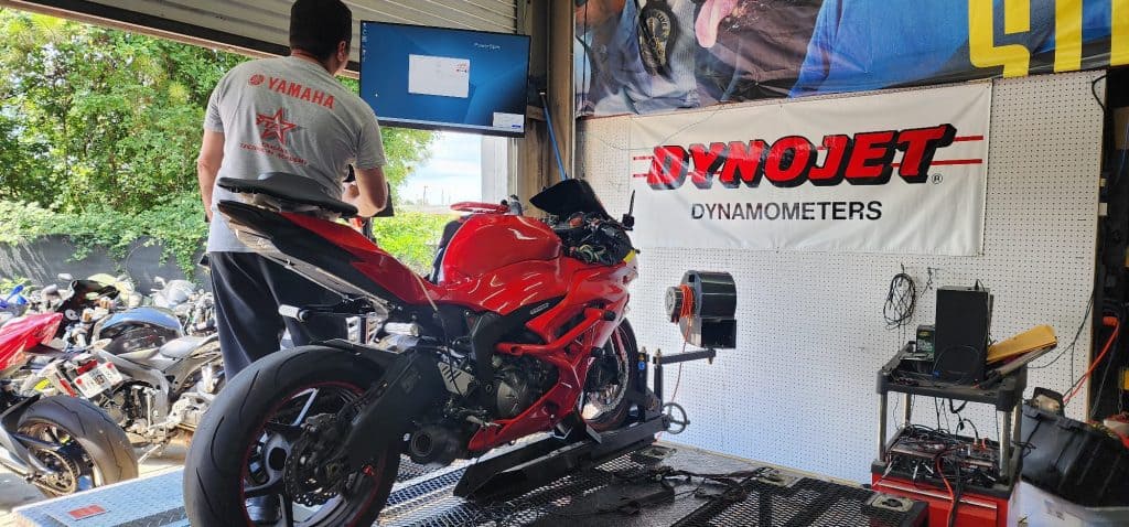 dyno jet tunning being performed on a red motorcycle.