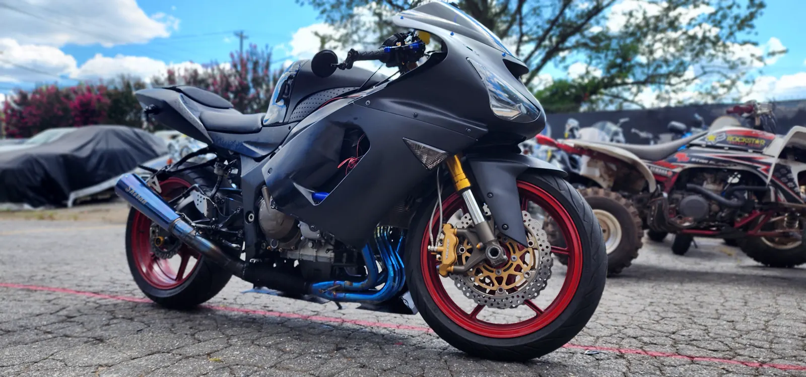 custom motorcycle painting Atlanta — matte black Kawasaki ZX-14 with red wheels, gold forks and blue anodized headers