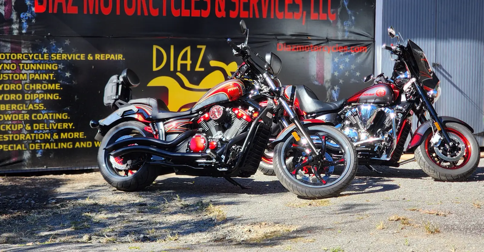 Custom motorcycle paint Atlanta — two red-and-black Yamaha cruisers with airbrushed graphics at Diaz