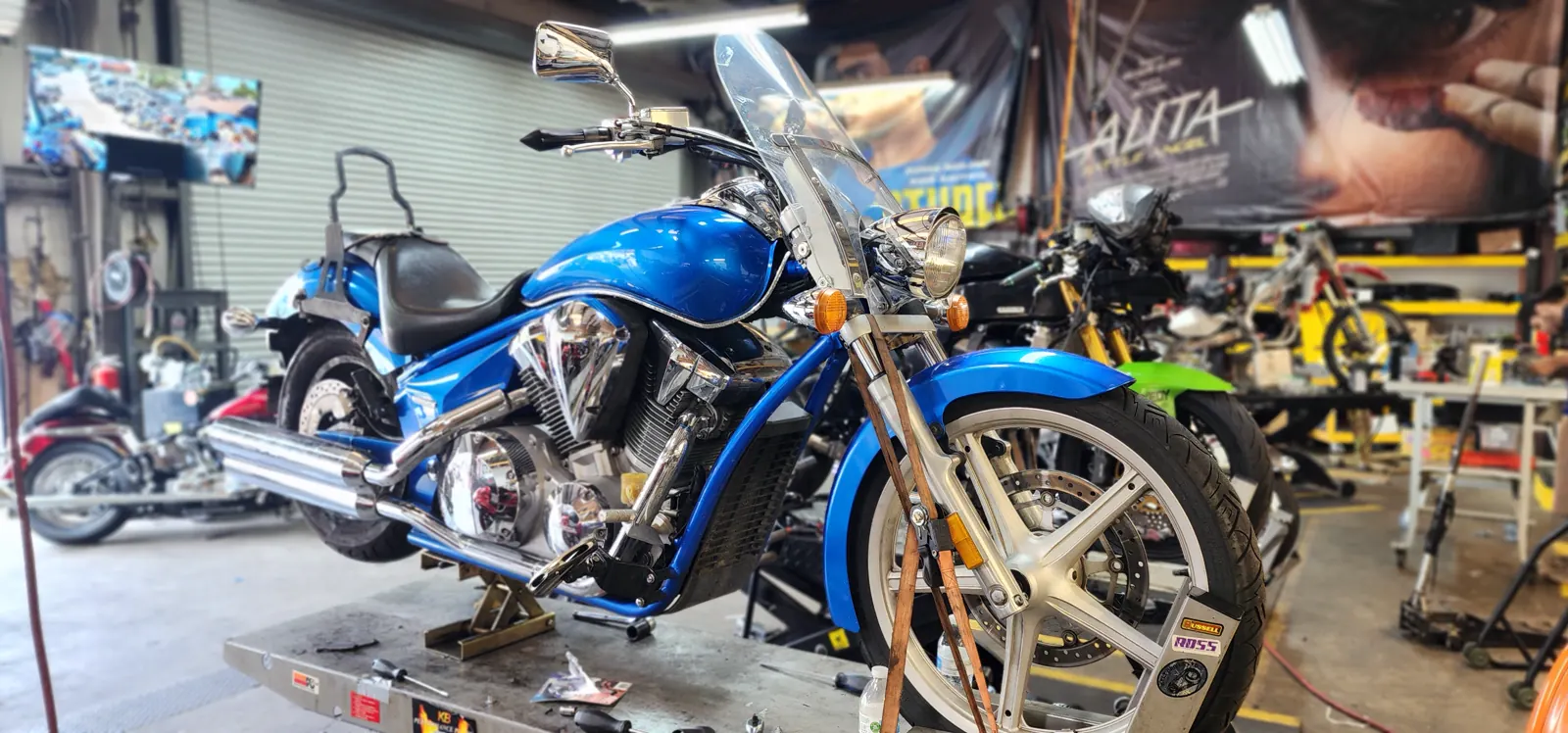 custom paint Douglasville — bright blue Honda Fury-style chopper with chrome engine up on a lift
