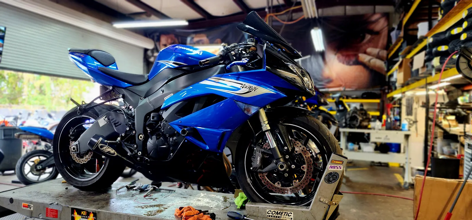 Motorcycle service Marietta — blue Kawasaki Ninja ZX-6R up on the lift table with tools and rags on the deck