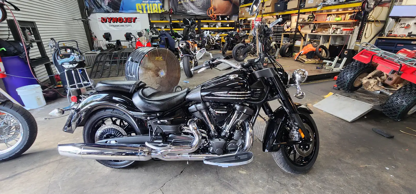 enclosed vs open transport Canton — black Yamaha Roadliner cruiser with heavy chrome parked inside the shop