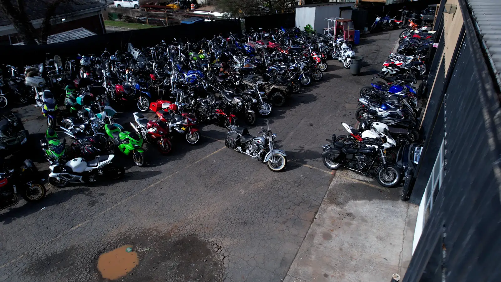 Motorcycle service near Kennesaw — drone view of the packed Diaz lot, silver Harley Softail in the center aisle