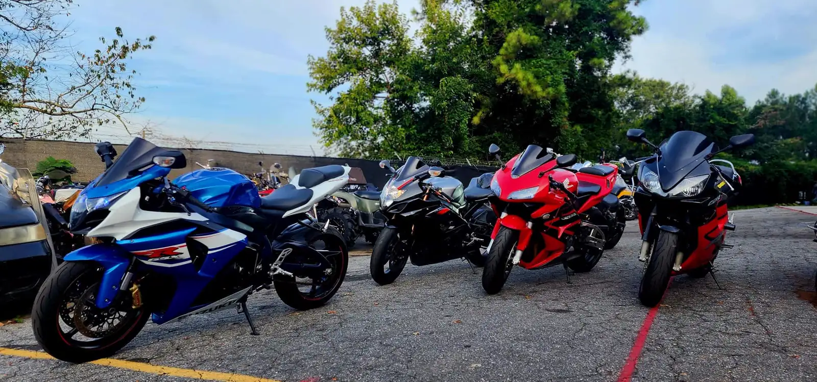 enclosed vs open transport Roswell — five sportbikes parked in a row on the Diaz asphalt lot