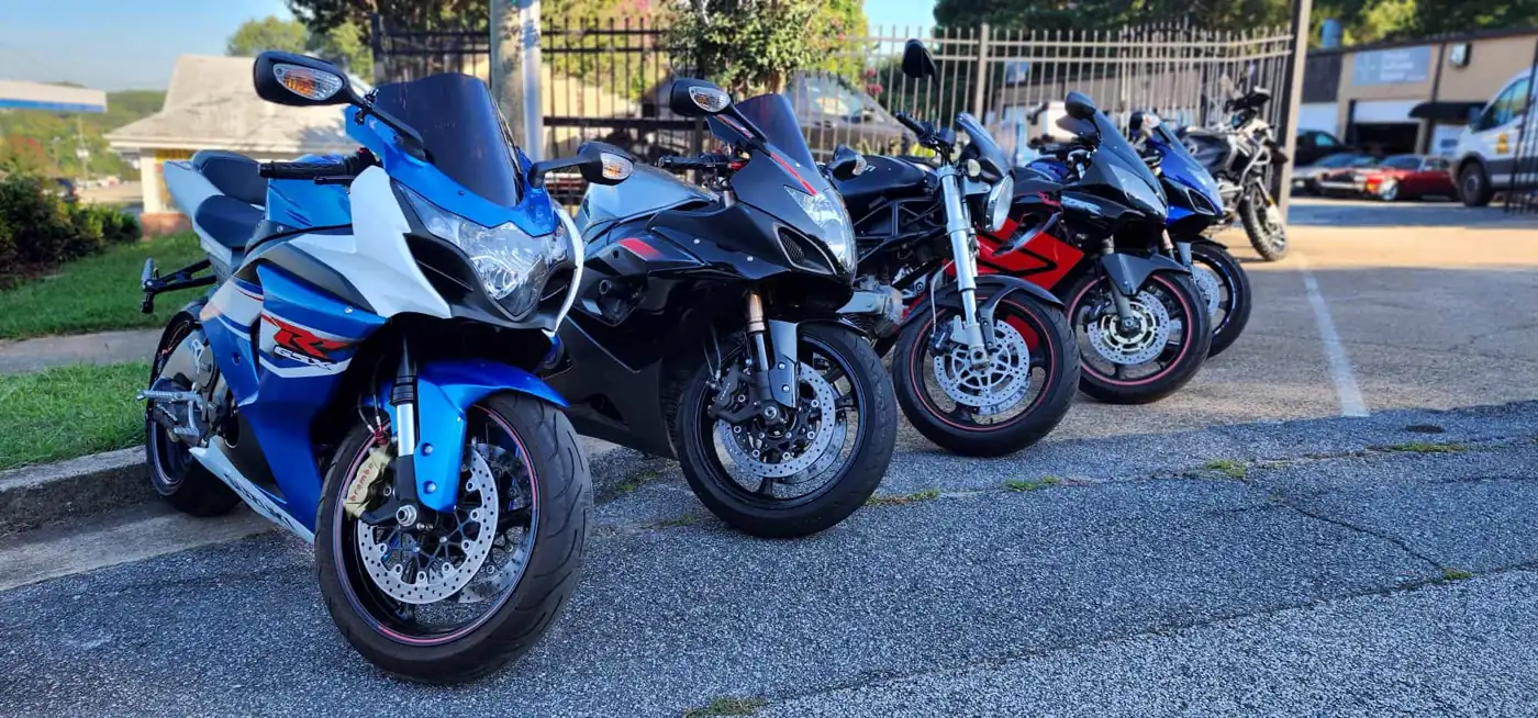 motorcycle transport Roswell — four sportbikes lined up on the Diaz shop lot, blue GSX-R in front