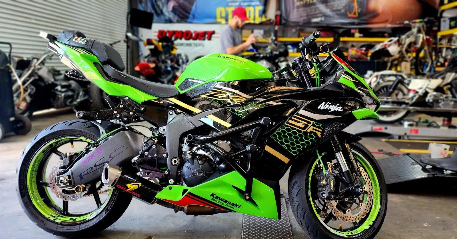 Motorcycle repair Acworth trusts — green and black Kawasaki Ninja ZX-6R KRT parked near the dyno area