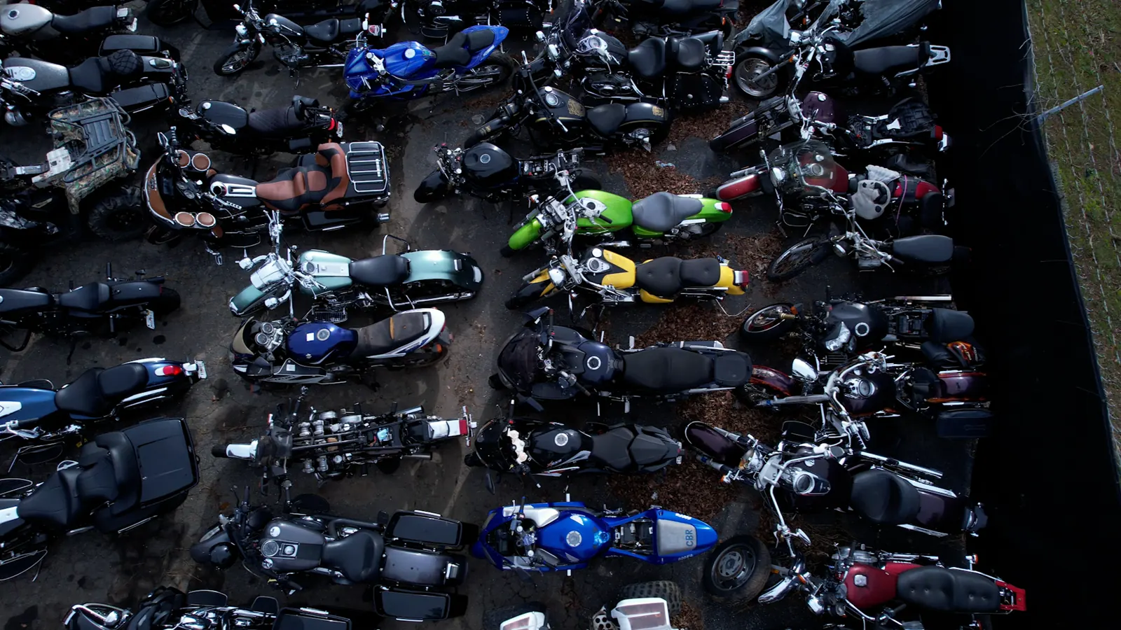 Overdue motorcycle service Woodstock — overhead drone view of dozens of bikes parked in tight rows on our lot