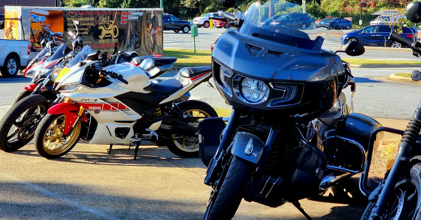 Motorcycle service Roswell — customer bikes at golden hour including an Indian Challenger bagger and a Yamaha R6