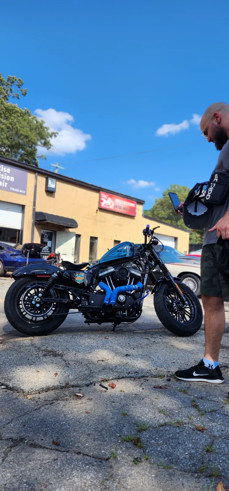 Motorcycle transport Woodstock — black Harley Forty-Eight with teal tank parked on the Diaz lot