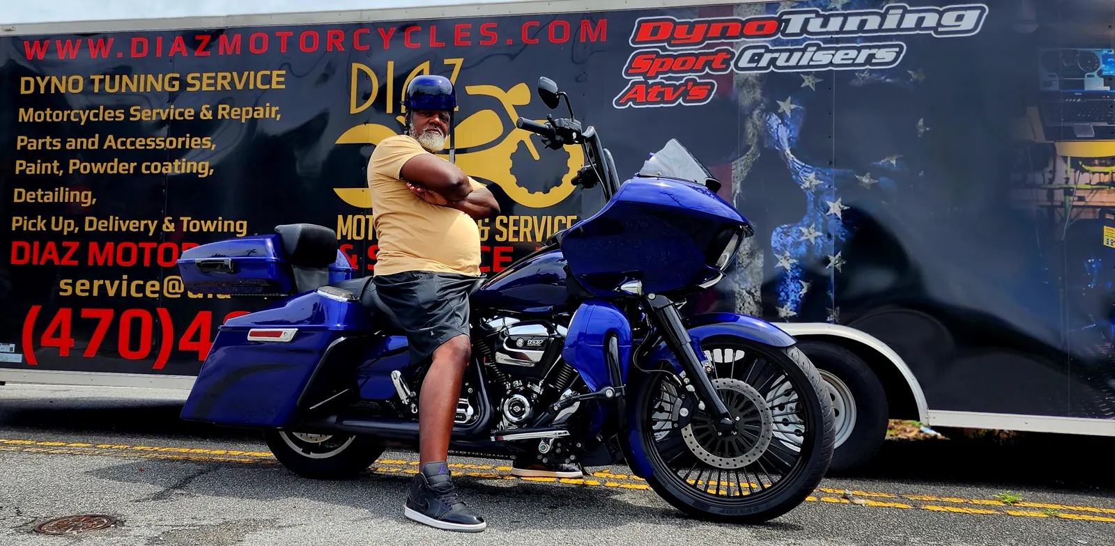 motorcycle transport cost Acworth — customer standing with a purple Road Glide bagger by the Diaz trailer