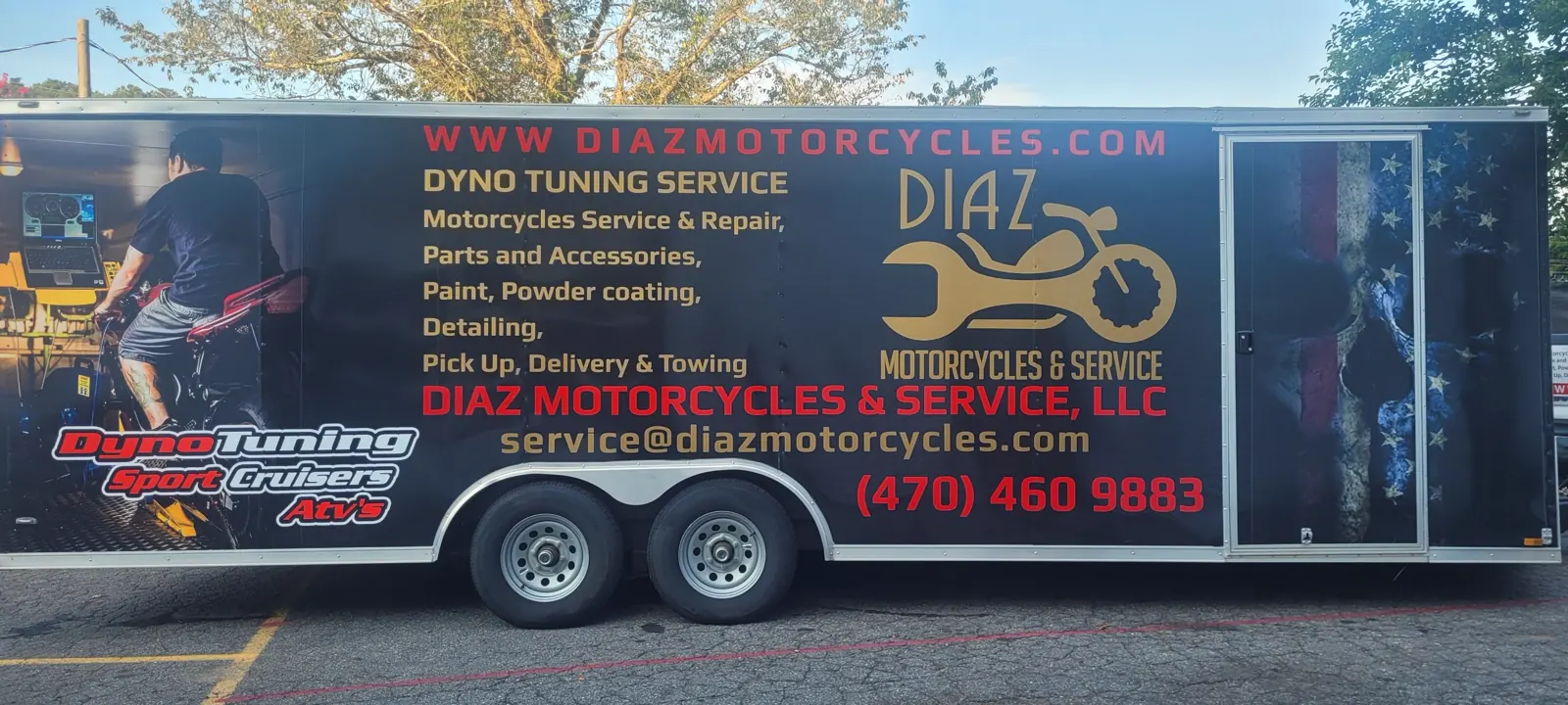 enclosed vs open transport Kennesaw — full side profile of the black Diaz enclosed trailer with flag graphics
