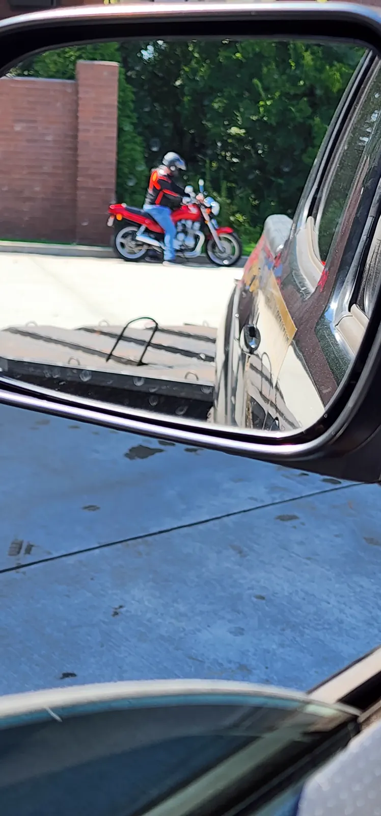 transport company Powder Springs — view through a truck mirror of a red naked bike above an empty flatbed deck