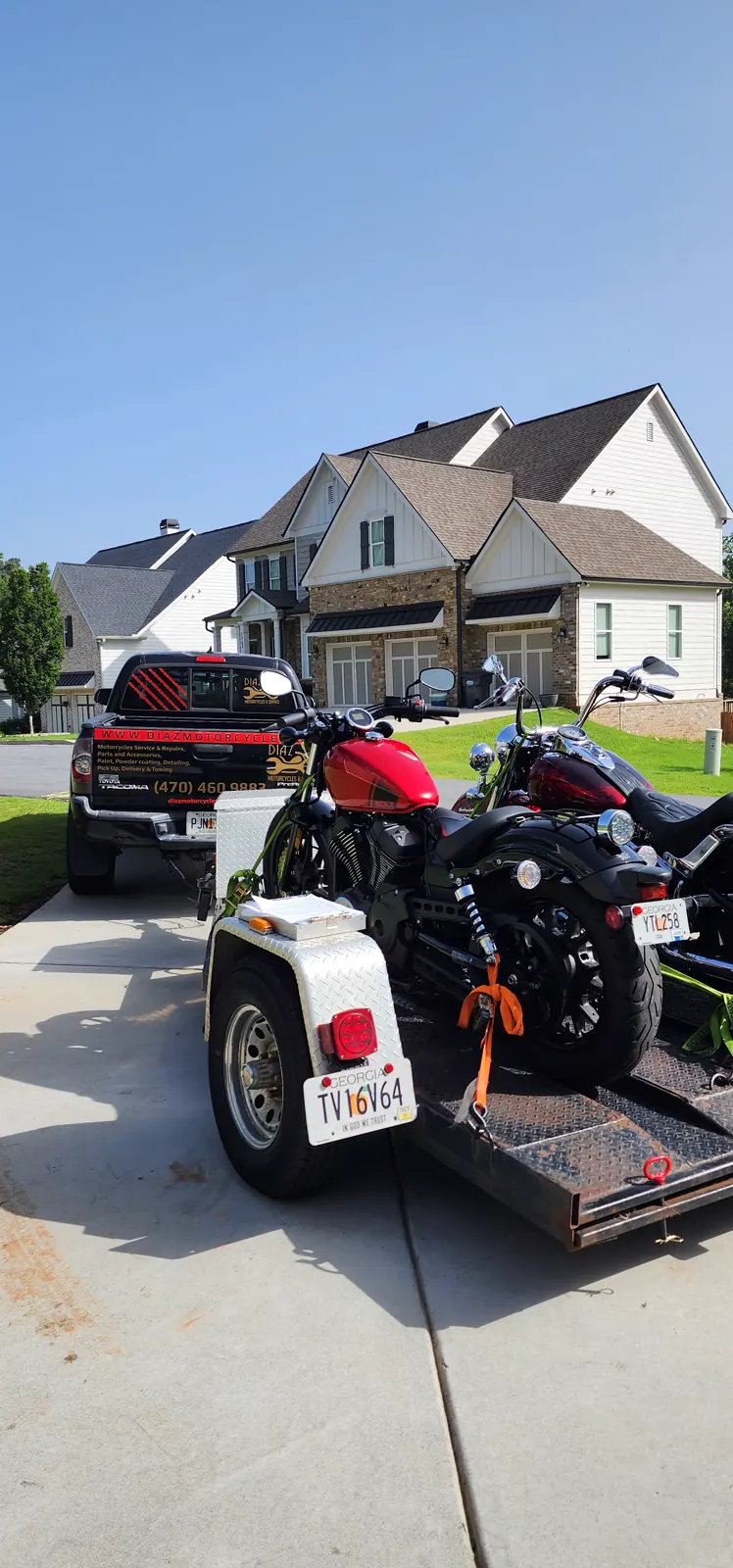 motorcycle transport Roswell — Diaz Tacoma and open trailer loaded with a red Harley Forty-Eight