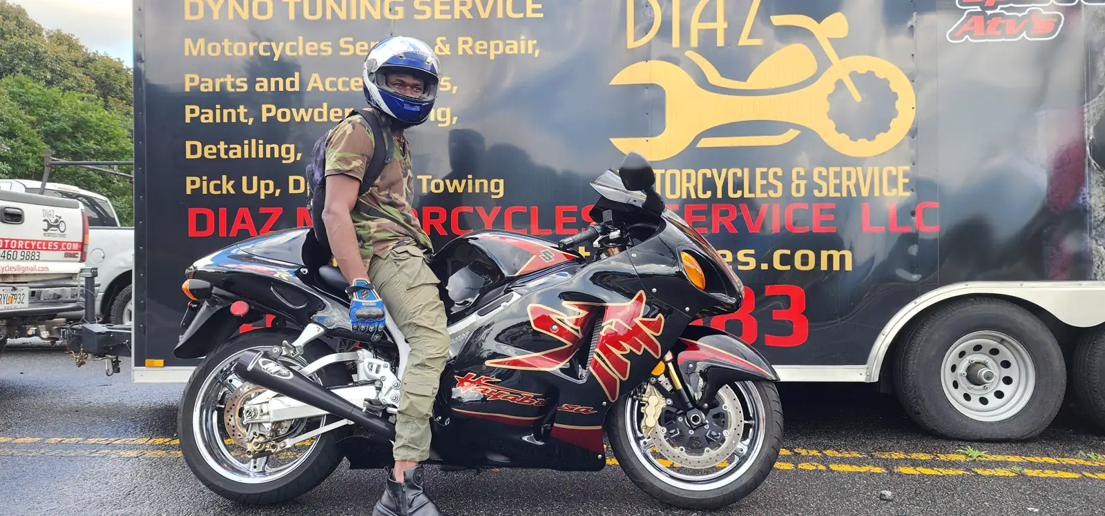 Stranded motorcycle pickup Roswell — rider in camo on a red and black Hayabusa by the Diaz trailer